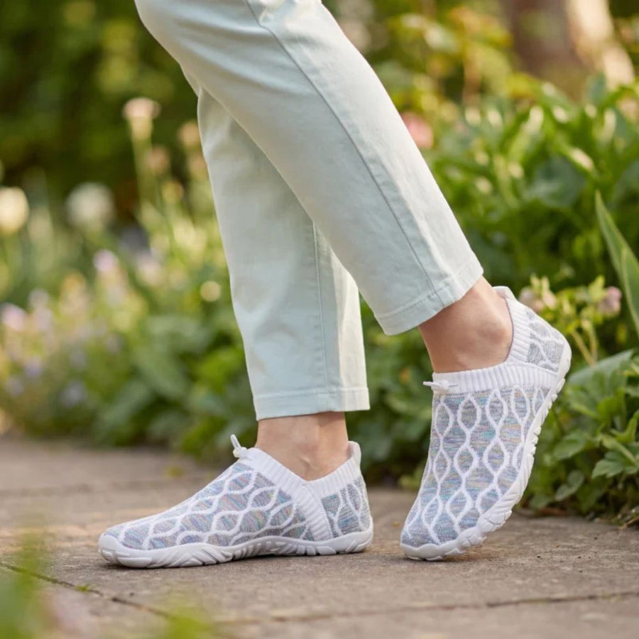 Walking through the garden, light on her feet